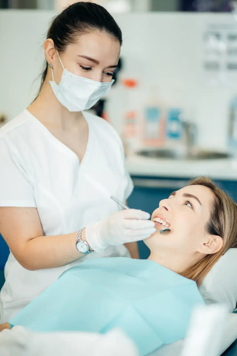 Dentist treating a patient in the chair