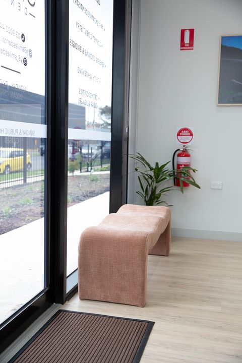 Glass entrance and seating inside the front door of Y3 Smiles Dental