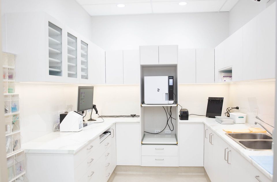 Sterilisation room with steriliser, sinks and storage at Y3 Smiles Dental