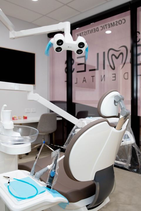 Dental chair with overhead light in a Y3 Smiles Dental treatment room